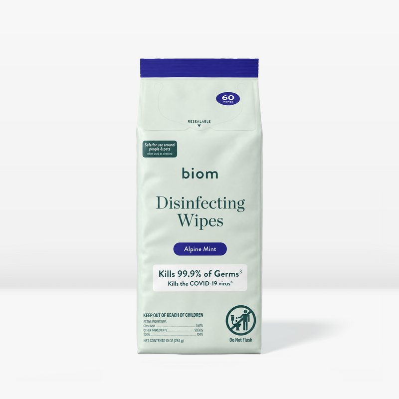 A package of biom Disinfecting Wipes in Alpine Mint flavor, featuring a light mint green bag with a dark blue top seal and text, set against a clean white background.
