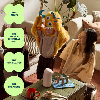 Child in a monster costume interacting with a woman in a living room setting, with product features highlighted.
